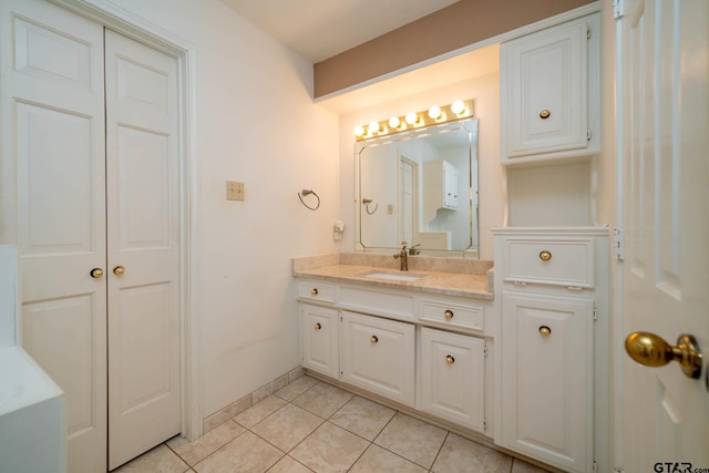 bathroom with baseboards, vanity, and tile patterned floors