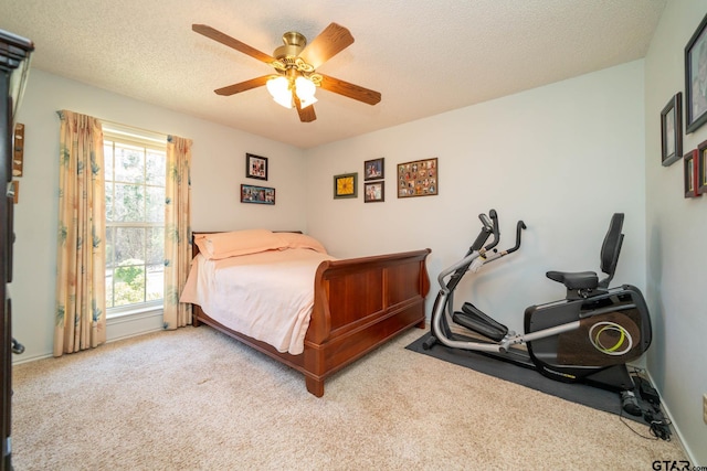 carpeted bedroom with baseboards, multiple windows, a ceiling fan, and a textured ceiling