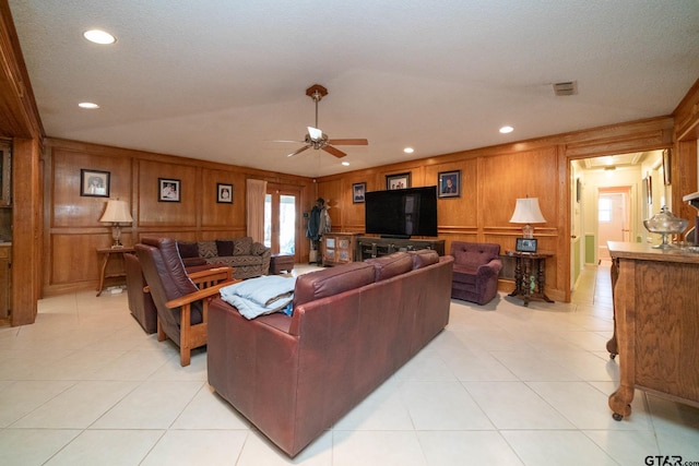 living area featuring light tile patterned floors, a ceiling fan, and recessed lighting