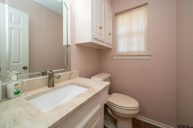 half bathroom featuring toilet and vanity