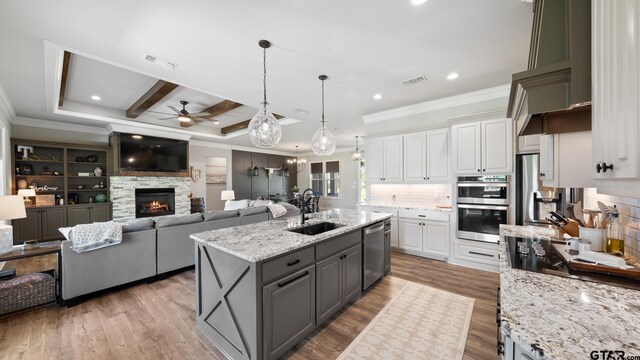 kitchen featuring visible vents, a ceiling fan, crown molding, a sink, and stainless steel appliances