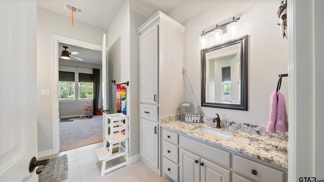 bathroom featuring ceiling fan, vanity, tile patterned floors, baseboards, and visible vents