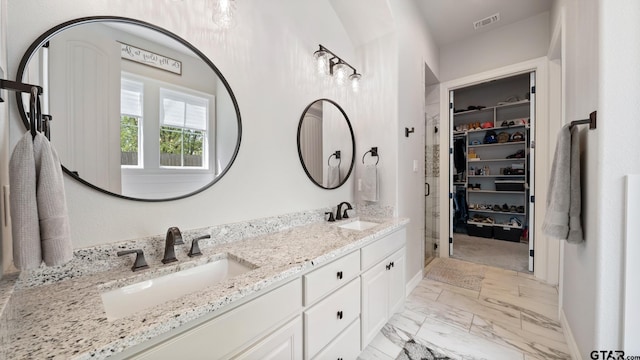 bathroom featuring baseboards, a sink, marble finish floor, and visible vents