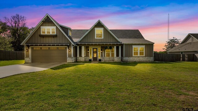 craftsman inspired home with fence, stone siding, and a garage