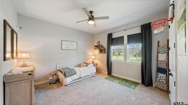 carpeted bedroom with baseboards and ceiling fan