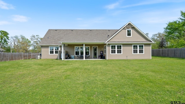back of property with a lawn, a patio, and a fenced backyard