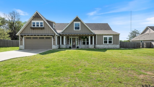 craftsman-style home featuring fence, stone siding, and concrete driveway
