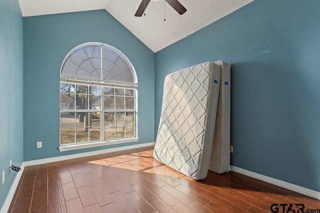 unfurnished room with hardwood / wood-style flooring, ceiling fan, and lofted ceiling