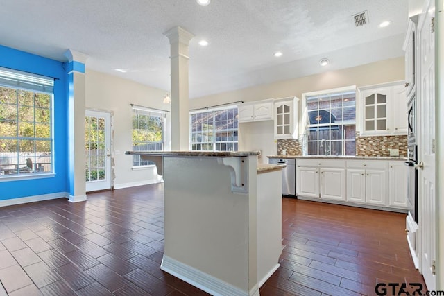 kitchen with white cabinetry, a healthy amount of sunlight, and appliances with stainless steel finishes