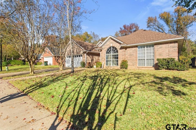 single story home featuring a front yard and a garage