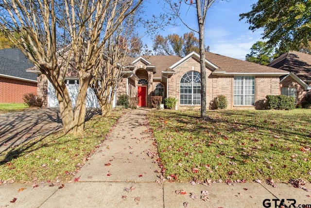 ranch-style home featuring a front yard