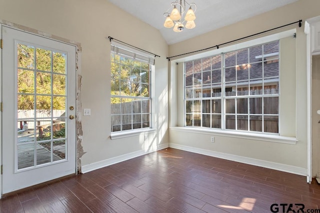 entryway featuring a chandelier, dark hardwood / wood-style flooring, and lofted ceiling