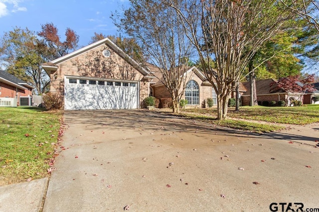 view of front of home with a garage and a front lawn