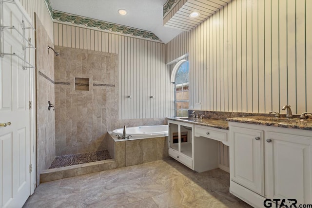 bathroom featuring plus walk in shower, vanity, and vaulted ceiling