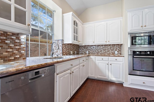 kitchen with white cabinets, sink, light stone countertops, and stainless steel appliances