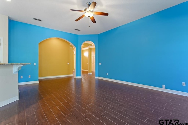 spare room featuring ceiling fan and dark wood-type flooring