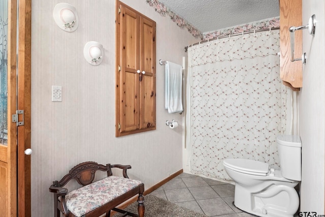 bathroom featuring walk in shower, a textured ceiling, tile patterned floors, and toilet