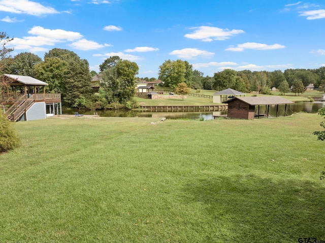 view of yard featuring a deck with water view