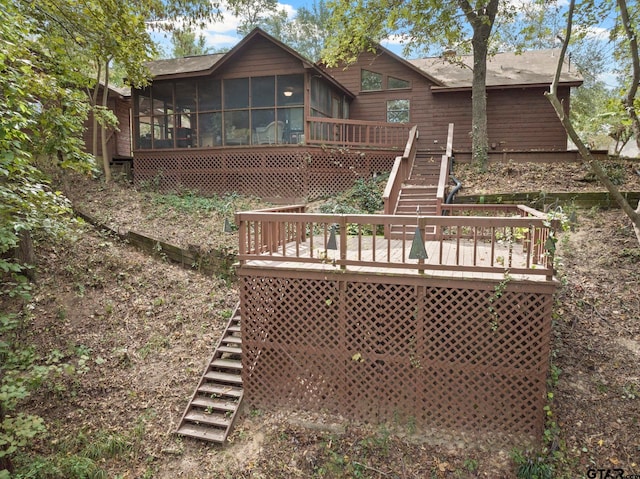 back of property featuring a sunroom and a wooden deck