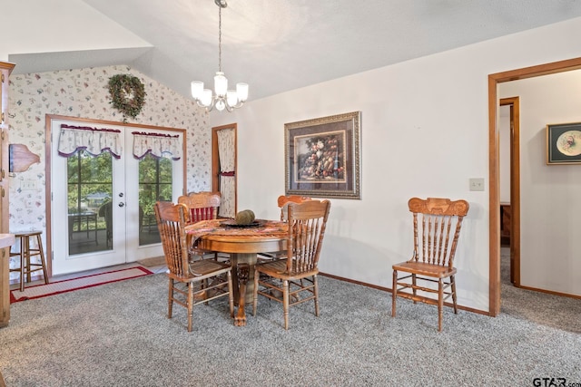 dining area featuring carpet flooring, french doors, vaulted ceiling, and an inviting chandelier