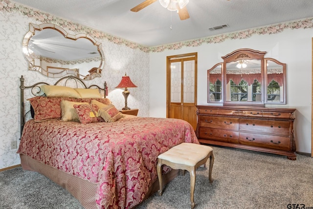 bedroom with a textured ceiling, ceiling fan, and carpet floors