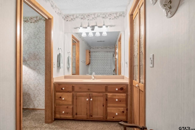 bathroom with vanity and a textured ceiling