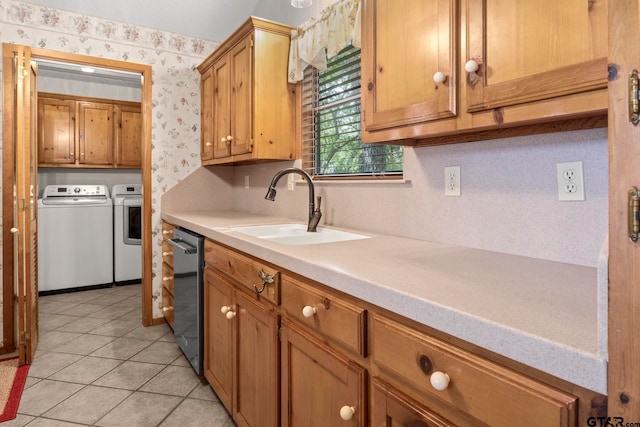 kitchen featuring dishwasher, light tile patterned flooring, sink, and separate washer and dryer