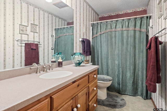 bathroom with a shower with curtain, a textured ceiling, vanity, tile patterned floors, and toilet