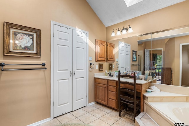 10769 Indigo Ln, Flint, TX 75762 - bathroom featuring vanity, vaulted ceiling, tile patterned floors, a bath, and a skylight