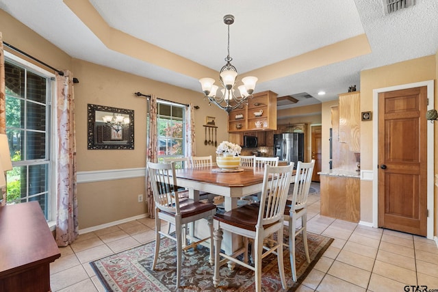 10769 Indigo Ln, Flint, TX 75762 - dining room featuring a chandelier, a raised ceiling, light tile patterned floors, and a textured ceiling