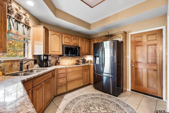 10769 Indigo Ln, Flint, TX 75762 - kitchen featuring stainless steel fridge with ice dispenser, decorative backsplash, light tile patterned floors, black electric cooktop, and light stone counters