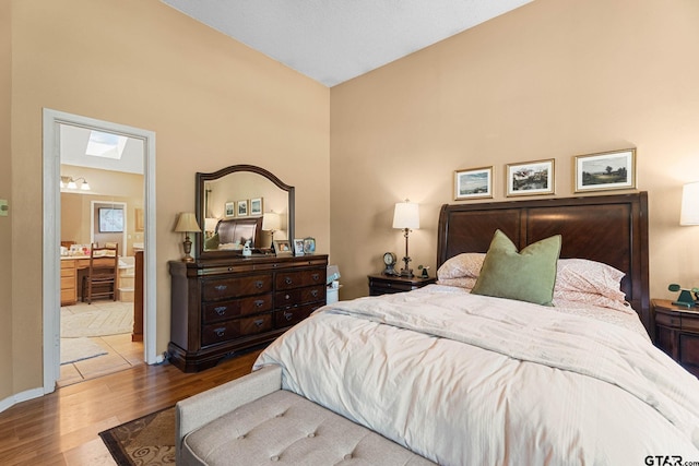 10769 Indigo Ln, Flint, TX 75762 - bedroom featuring wood finished floors, ensuite bath, and high vaulted ceiling