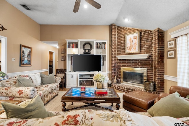 10769 Indigo Ln, Flint, TX 75762 - living area featuring a textured ceiling, vaulted ceiling, ceiling fan, and a brick fireplace