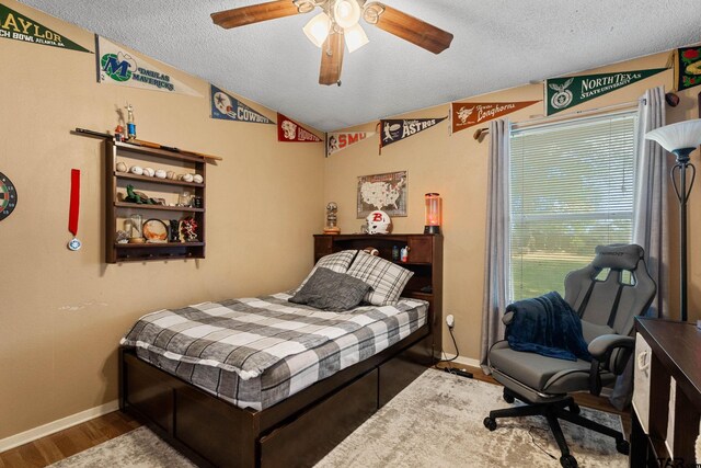 10769 Indigo Ln, Flint, TX 75762 - bedroom with a textured ceiling, vaulted ceiling, ceiling fan, and wood finished floors