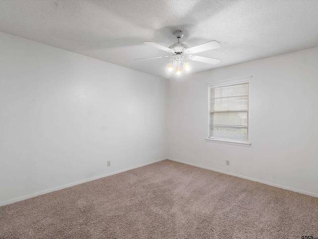 carpeted empty room featuring a textured ceiling, ceiling fan, and baseboards