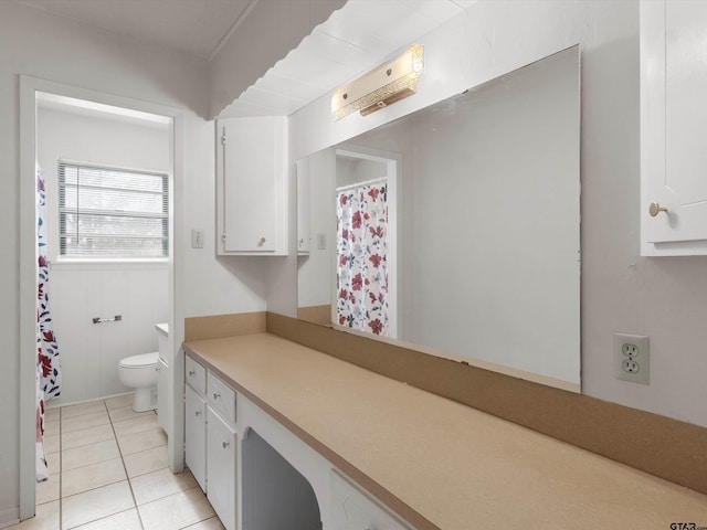 bathroom with curtained shower, vanity, toilet, and tile patterned floors