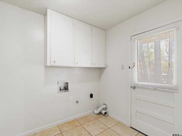 clothes washing area featuring light tile patterned floors, washer hookup, baseboards, cabinet space, and electric dryer hookup