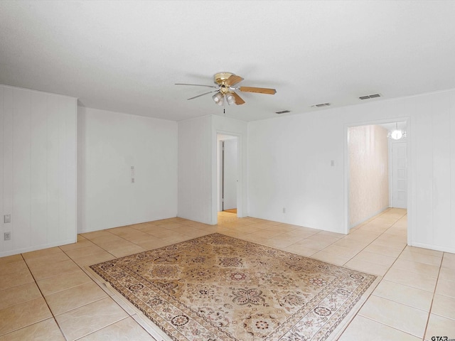 spare room featuring light tile patterned floors, ceiling fan, and visible vents