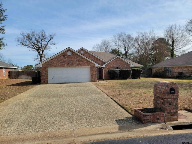 view of front of house with concrete driveway, an attached garage, fence, a front lawn, and brick siding