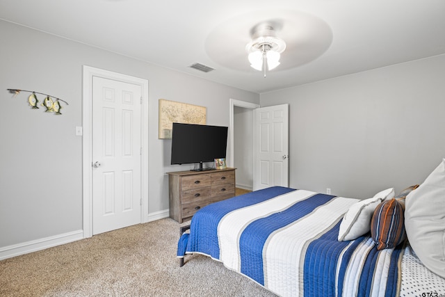 carpeted bedroom with visible vents, baseboards, and ceiling fan