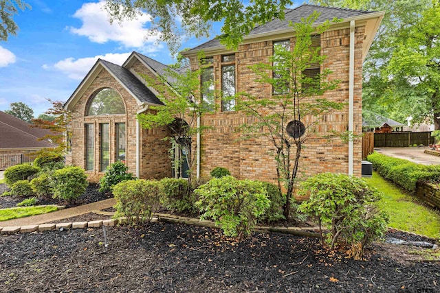 traditional home with brick siding and fence