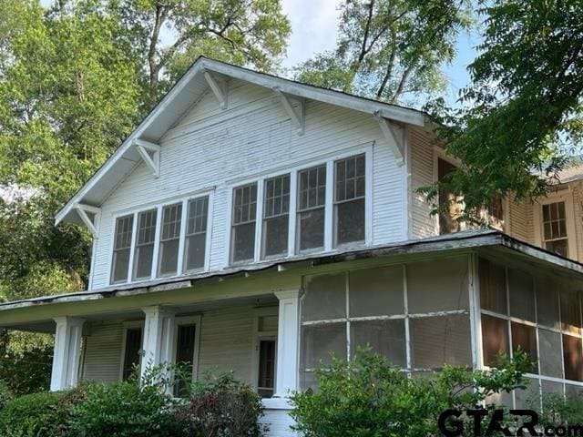 view of side of property featuring a sunroom