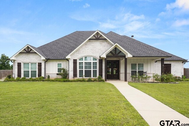 429 Coventry, Bullard, TX 75757 - view of front of property with french doors, roof with shingles, board and batten siding, a front yard, and brick siding