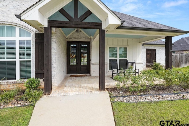 429 Coventry, Bullard, TX 75757 - view of exterior entry featuring roof with shingles, board and batten siding, french doors, brick siding, and covered porch