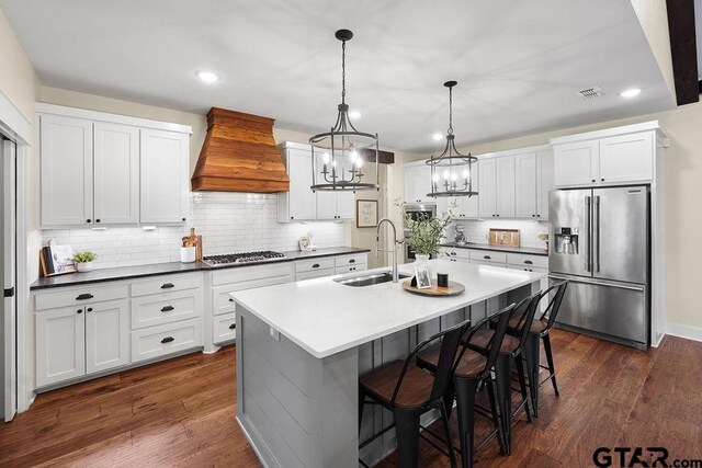 429 Coventry, Bullard, TX 75757 - kitchen with stainless steel appliances, a sink, custom range hood, backsplash, and a kitchen bar