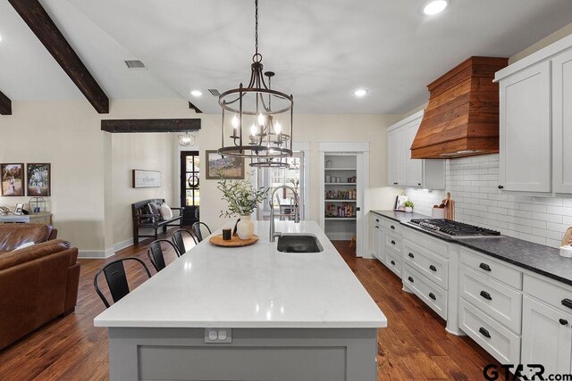 429 Coventry, Bullard, TX 75757 - kitchen featuring a sink, stainless steel gas cooktop, a chandelier, custom exhaust hood, and decorative backsplash