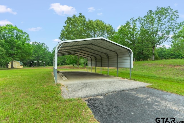 841 Pops Landing Rd, Ore City, TX 75683 - view of parking / parking lot featuring a detached carport, driveway, and a storage unit