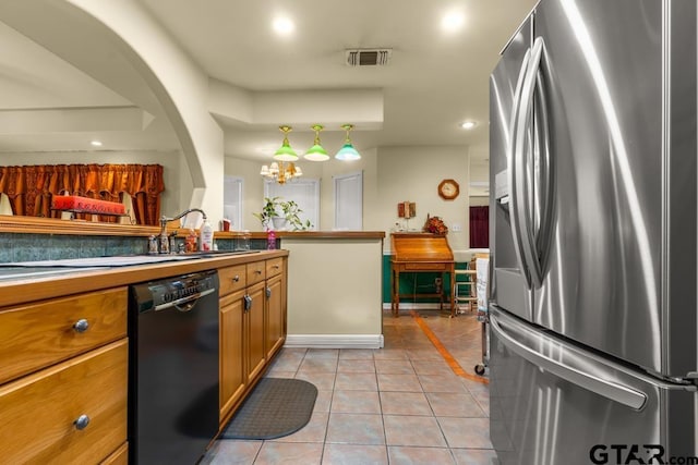 841 Pops Landing Rd, Ore City, TX 75683 - kitchen with stainless steel fridge with ice dispenser, dishwasher, light tile patterned flooring, brown cabinets, and recessed lighting