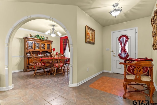841 Pops Landing Rd, Ore City, TX 75683 - tiled foyer featuring arched walkways and a chandelier