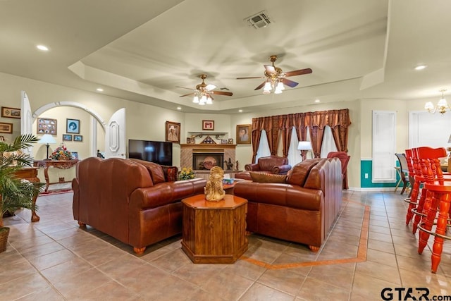 841 Pops Landing Rd, Ore City, TX 75683 - living room with a tray ceiling, light tile patterned flooring, a ceiling fan, recessed lighting, and a chandelier